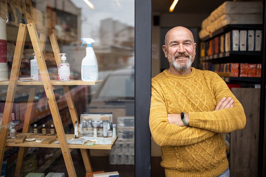 Business owner standing in front of his store