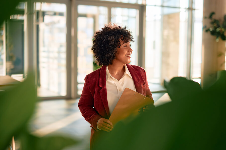 Business woman carrying clipboard