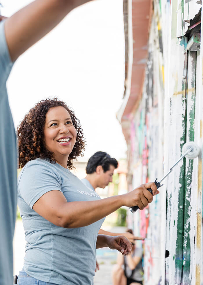 Community volunteers painting a wall