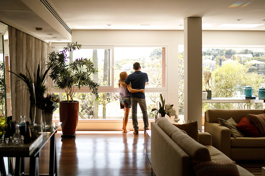Couple looking out window of new home