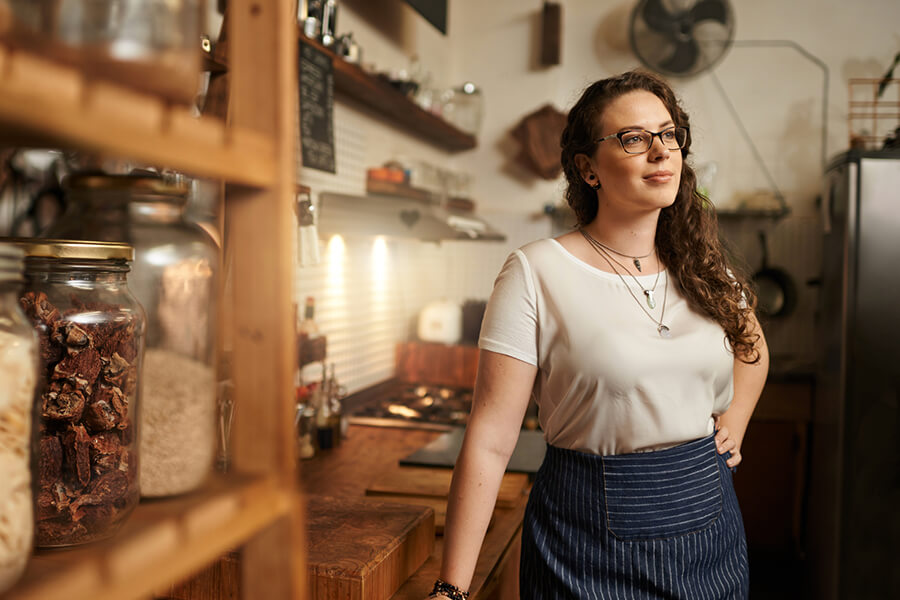 Female entrepreneur looking out at shop
