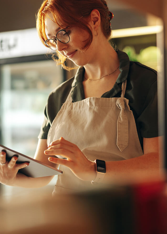 Female business owner looking at tablet