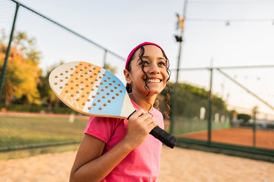 Girl holding a racket at courts