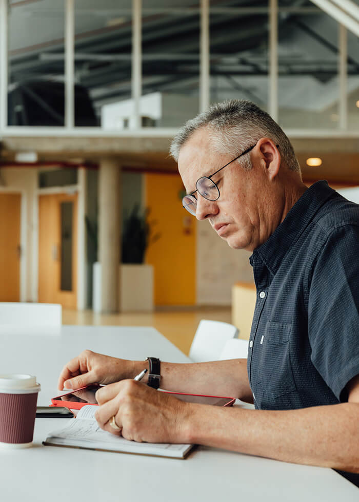 Male architect writing in notebook