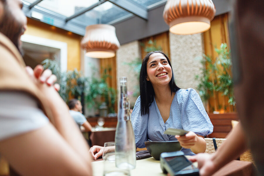 Woman paying with card at table
