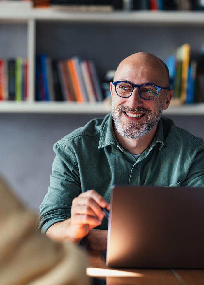 Smiling man with laptop