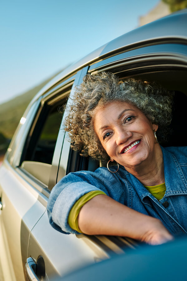 Woman leaning out of car window